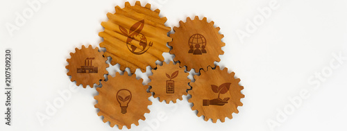 Quadro su tela A creative arrangement of wooden gears showcasing eco-friendly symbols that emphasize sustainable business practices, innovation, and environmental responsibility