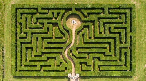 Problem Solving Concept, Aerial View of a Green Hedge Maze With One Clear Path