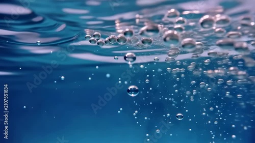 Close-up underwater bubbles rising in clear water