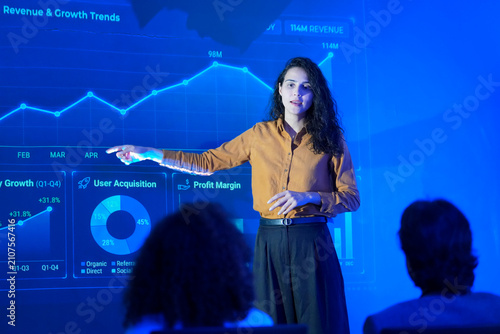 Business presentation shows revenue and growth trends in a conference room with audience listening attentively