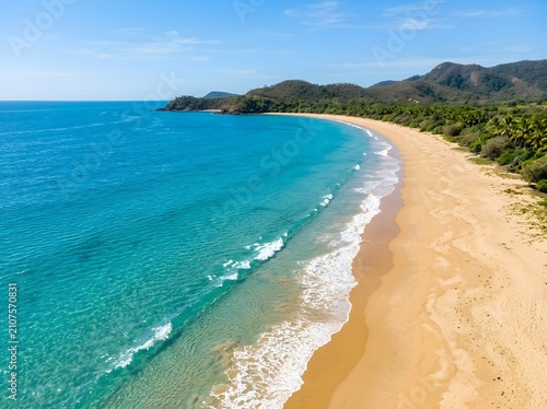 Aerial view of a tropical beach with turquoise water and golden sand coastal landscape