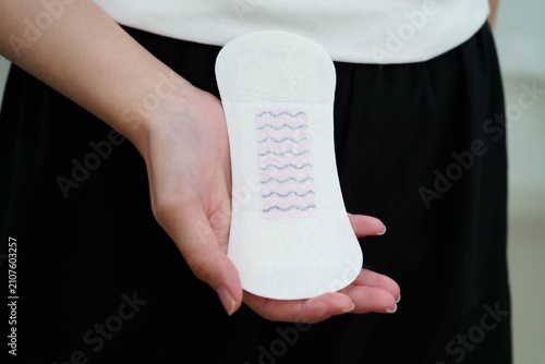 Cuadro en lienzo Asian woman holding sanitary napkin pad for hygiene menstrual period cycle protection