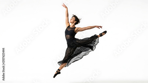 Woman in black dress leaping gracefully in mid-air with arms outstretched female dancer ballet