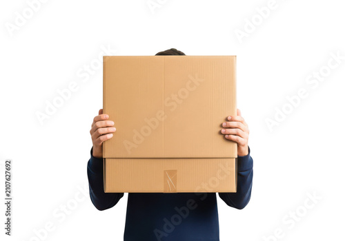 Man holding large cardboard box in front of face isolated on transparent background delivery, moving house, parcel shipping or logistics concept