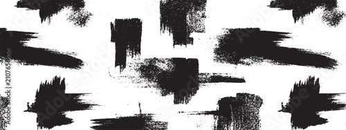 Quadro su tela Artistic black brush strokes and paint splatters on white background creating dy