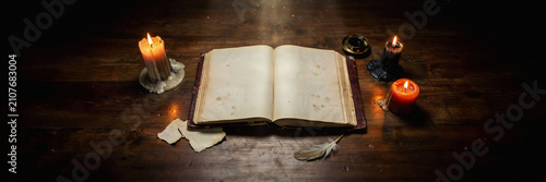 Antique open book resting on rustic wood with candlelight and old paper parchment background research knowledge literary mystical atmosphere decoration narrative inspiration heritage
