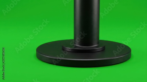 Black circular stand base on green screen background