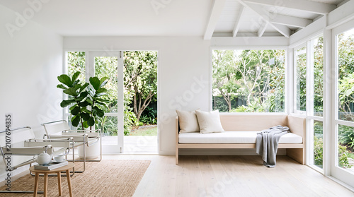 Bright white sunroom with daybed and lush garden views