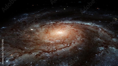 The glowing core of a distant spinning spiral galaxy in outer space.