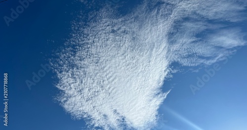 Bild auf Leinwand Feathery Cirrus Clouds Across a Deep Blue Sky