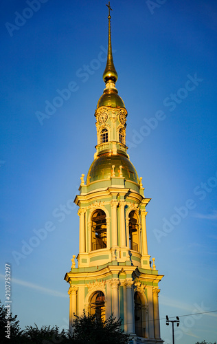Golden Church Bell Tower Against Blue Sky