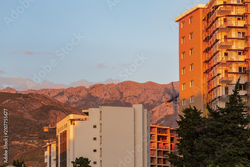 Photography Apartment buildings in Bar Montenegro with mountains at sunset, modern city life