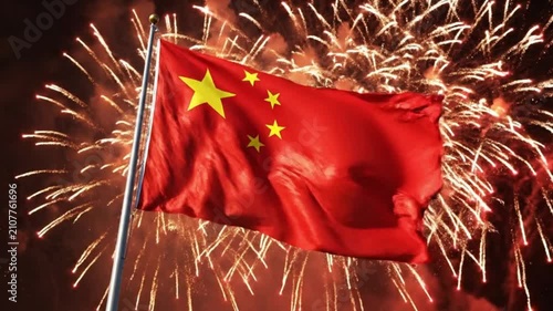 Chinese flag waving against background of exploding fireworks