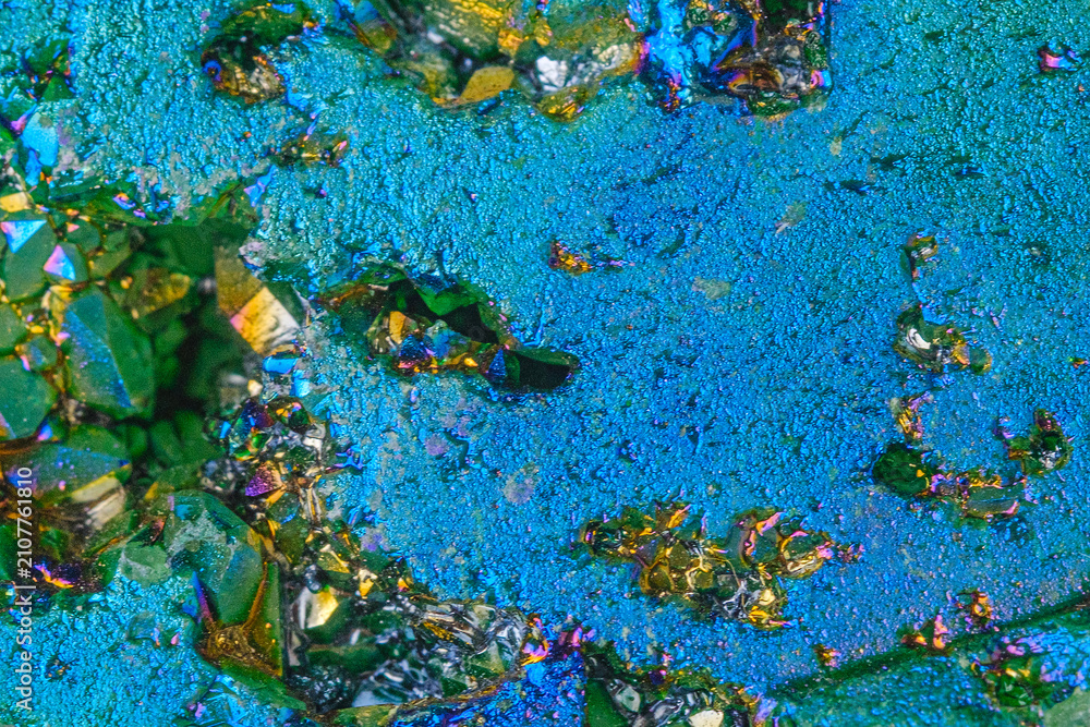 Naklejka premium Close up of colorful crystal and mineral textures with iridescent blue background
