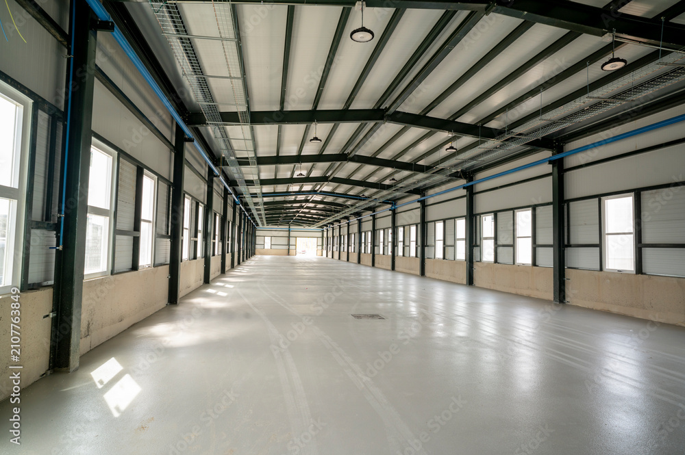 Fototapeta premium Spacious empty hangar with metal frame beams