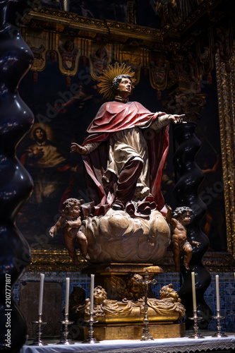 фотографія Baroque statue of Saint Peter Arbues on a cloud with cherubs inside the Chapel of San Pedro Arbues at the Cathedral of La Seo, dramatic sacred art sculpture in Zaragoza