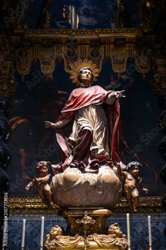 фотографія Baroque statue of Saint Peter Arbues on a cloud with cherubs inside the Chapel of San Pedro Arbues at the Cathedral of La Seo, dramatic sacred art sculpture in Zaragoza