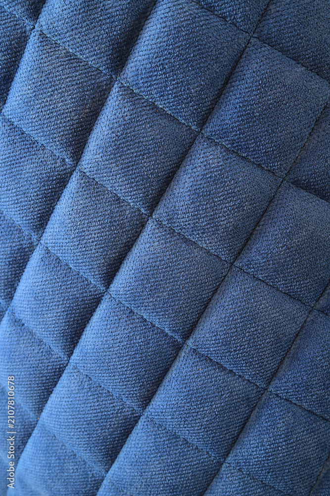 Obraz premium Blue quilted chair fabric texture