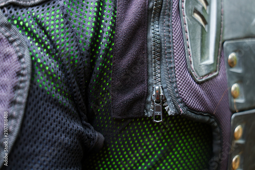 Green mesh motorcycle jacket with protective armor and metal zipper detail creating rugged urban riding vibe