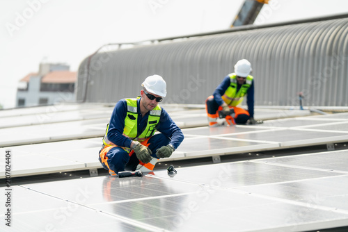 Vászonkép Team of professionals installing solar panels on a rooftop to promote renewable
