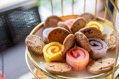 Obraz na plátne Colorful jam swirl petit four and assorted cookie assortment on tiered serving t