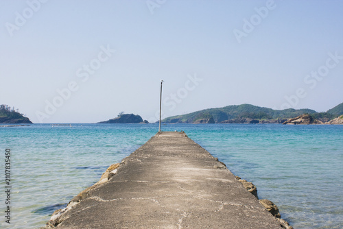 Obraz na plátne Concrete Pier on Crystal Clear Sea near a Fishing Harbor in Shimane Japan