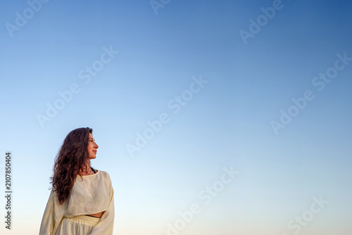 Quadro su tela Woman with curly hair looking confidently towards new horizons, contemplating fu