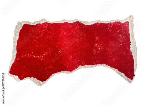 A small piece of torn red paper with rough edges