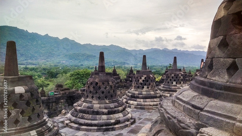 Photos Ancient stone stupas of Borobudur Temple set against a mountain backdrop