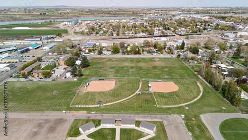 Quadro su tela Aerial view of baseball diamonds in a small town park surrounded by trees and homes