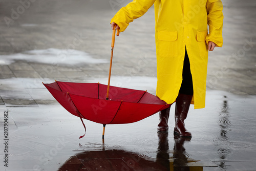 Woman in raincoat with red ...
