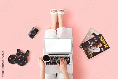 Woman using laptop with cof...