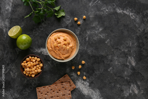 Bowl of tasty hummus with l...