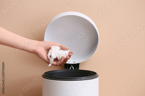 Woman throwing white crumpl...