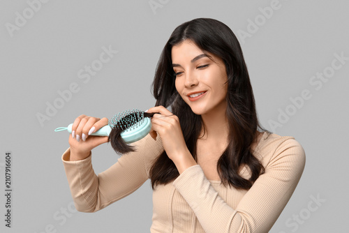 Beautiful young woman brush...