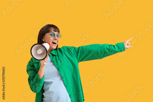 Young woman with megaphone ...