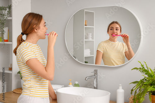 Beautiful young woman brush...