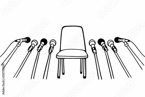 Empty chair with multiple microphones for press conference. Professional interview setup with audio equipment and seating arrangement.
