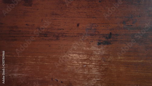 Rich wooden texture with dark brown hues and subtle light reflections creating an organic feel