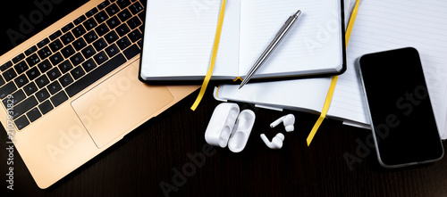 Dark Wooden Desk Flat Lay with Laptop, Notebook and Accessories