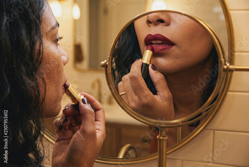 Hispanic Latina Woman Applying Burgundy Lipstick Mirror Reflection Makeup Routine Diverse Beauty