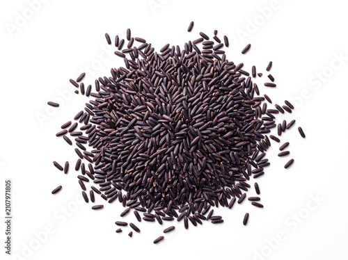 Heap of black rice grains isolated on white background showcasing nutritious whole grain superfood