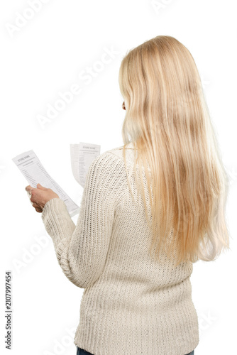 Back view of blonde woman checking shopping bills Holding transaction receipts for accounting records, budgeting, and expense documentation