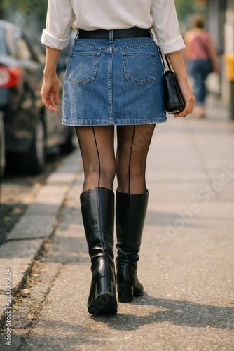 stunning woman in a denim skirt walking AI generated