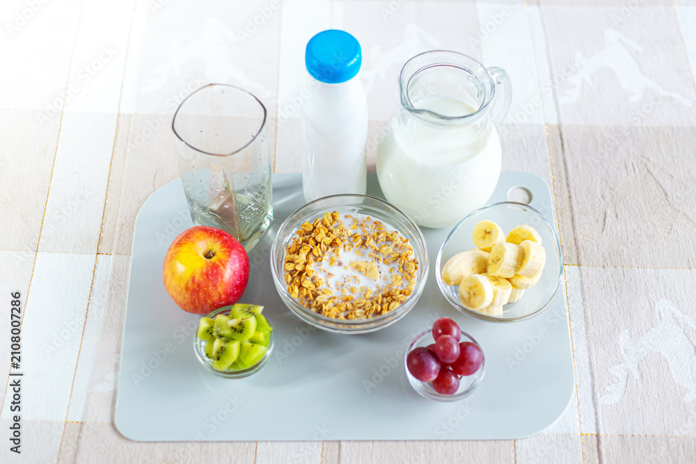Fototapeta premium Healthy breakfast - muesli, fruits and dairy products on the table.