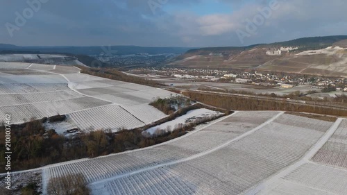 Moselle valley, winter season, snow and frost covered vineyard and river landscape near Trier, Germany, aerial view