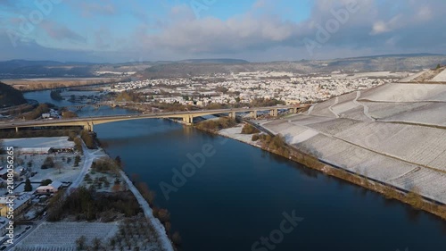 Snow covered Moselle valley, vineyards and Mosel river, Viaduct Longuich bridge of highway crossing near Trier, aerial view, winter season with frost in Germany
