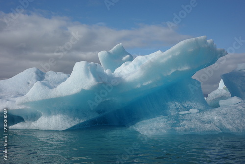 Obraz na plátně Blue iceberg floating in a glacial lagoon in Iceland