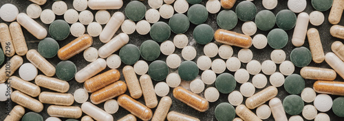 Top view flat lay background of various green chlorella pills and herbal capsules for healthy lifestyle organic dietary supplement and nutrition overview concept
