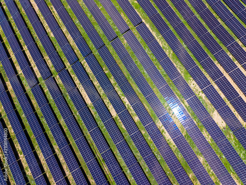 Canvastavla Solar panels on a large field showing rows of solar energy technology under brig